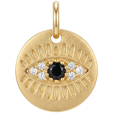 Gold evil eye coin charm brass with black and white zircon stones against clean neutral background