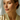 Woman wearing long chain pearl and CZ dangle earrings with pulled-back hair.