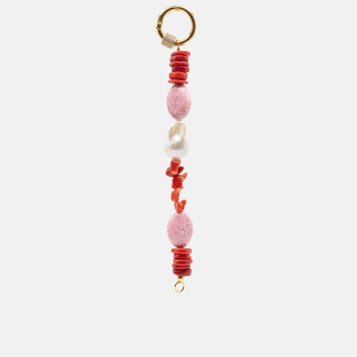 A beaded keychain or bag charm featuring textured coral red chips, two pink marbled beads, a white baroque pearl, and a gold-tone split ring at the top, shown against a light gray background.