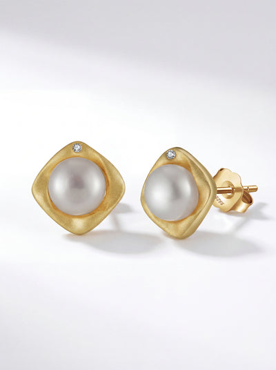 Golden Embrace stud earrings with freshwater pearl and gold cushion bezel