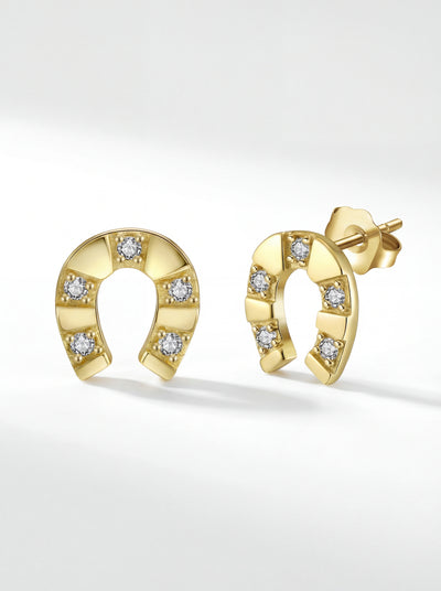Gold horseshoe stud earrings with CZ stones on clean background