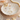 Jewelry set with Gold Horizon Kiss Rings featuring four different colored gemstones on a decorative shell dish.