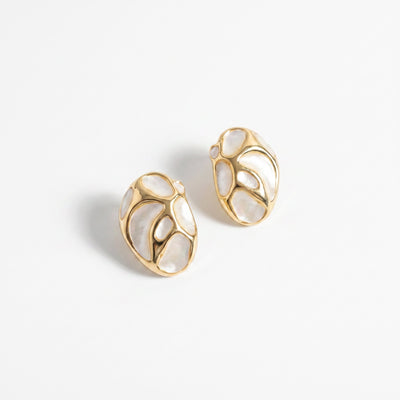 White nacre mosaic gold brass stud earrings on warm natural light linen surface