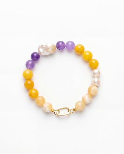 Purple yellow jade beaded bracelet with baroque pearls and gold clasp in warm natural light