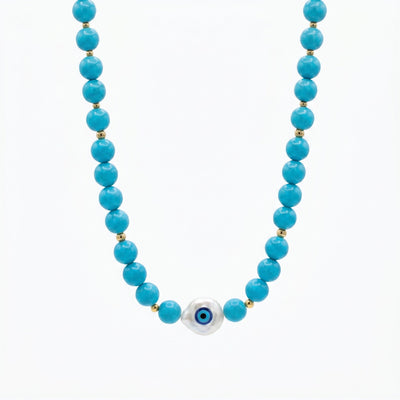 Turquoise evil eye beaded necklace baroque pearl pendant by Prasinous and Coral CharmLab on neutral background