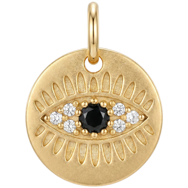 Gold evil eye coin charm brass with black and white zircon stones against clean neutral background