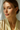 Woman wearing long chain pearl and CZ dangle earrings with pulled-back hair.