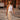 Pearl beaded necklace with gold starfish pendant worn by a model outdoors on a city street
