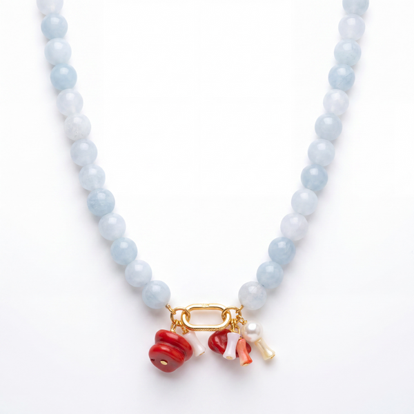 Aquamarine beaded necklace gold carabiner coral pearl charms on white background