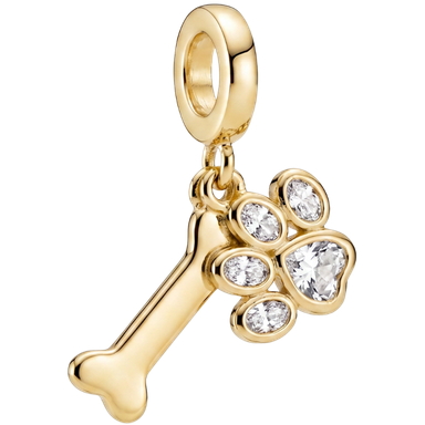 Gold-toned dog bone and paw print charm on jump ring shot in natural light