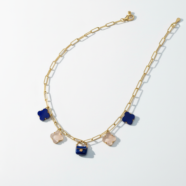 Close-up studio shot of miniature midnight blue enamel bag charm