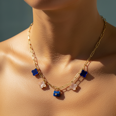 Model styling gold-plated blue bag charm on stacked charm bracelet