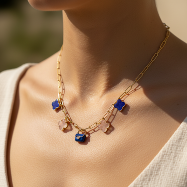 Blue enamel bag charm clipped onto carabiner charm necklace lifestyle shot