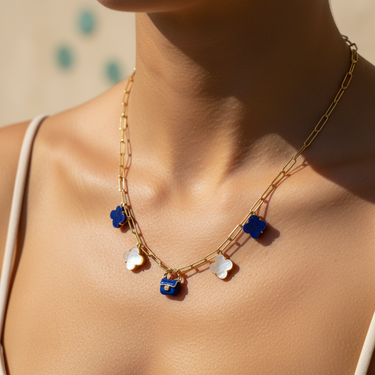 Model wearing blue enamel gold-plated bag charm on layered necklace