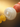 Close-up macro of a white mother of pearl bead with coral and yellow agate beads