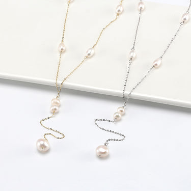 Freshwater pearl Y-necklace with gold and silver chain styling on display.