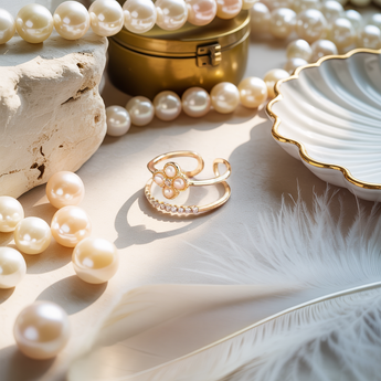 Golden bloom double layer adjustable ring with pearls and a gold box on a light surface