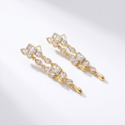 Gold-tone brass clear zircon long drop earrings warm light lifestyle close-up