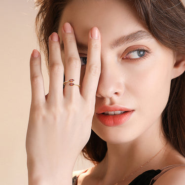 Horizon Kiss Ring with red marquise stones worn by model.