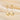 Gold seashell and pearl earrings on soft ivory background.