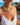 Model wearing jade gemstone necklace with baroque pearl pendant outdoors