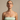 Woman wearing lucky step studs and a light green strapless top against a beige background