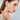 Model wearing long freshwater pearl drop earrings.