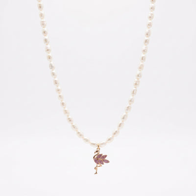 Gold-toned pink flamingo freshwater pearl pendant necklace on natural linen flat lay