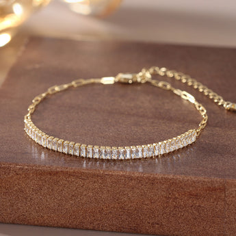 Close-up of gold radiant bar chain link bracelet with cubic zirconia.