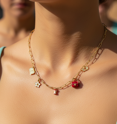Red enamel bag charm styled in flat lay with mixed enamel charm pendants