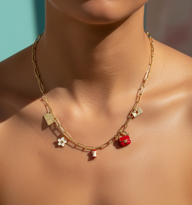Red enamel bag charm displayed alongside colorful collectible charm pendants