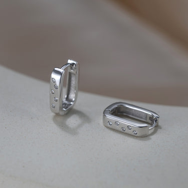 Rhodium-plated ShineLine Huggie earrings with CZ stones.