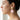 Drop earring with gold brass shell stud and pink pearlescent shell pendant, worn on a model