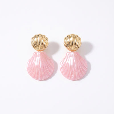 Drop earrings with gold metal shell studs and pearlescent pink resin shell pendants on white background