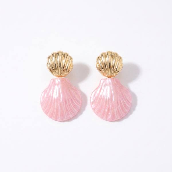 Drop earrings with gold metal shell studs and pearlescent pink resin shell pendants on white background