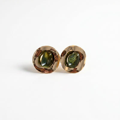 Shore moss green disc cabochon brass stud earrings in warm natural light lifestyle shot