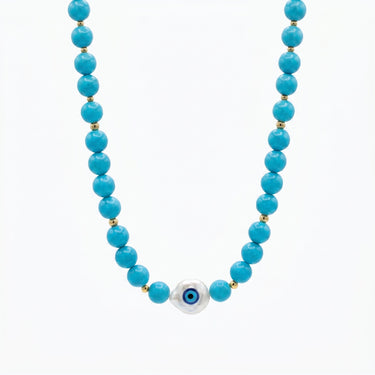 Turquoise evil eye beaded necklace baroque pearl pendant by Prasinous and Coral CharmLab on neutral background